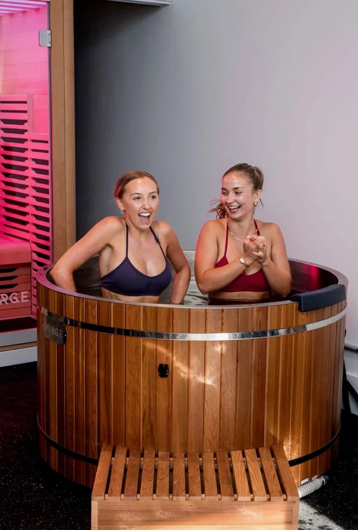 Two women sharing a cold plunge experience