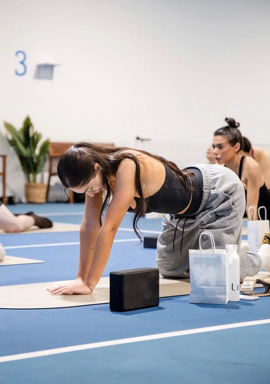 Pilates session taking place on a blue indoor court