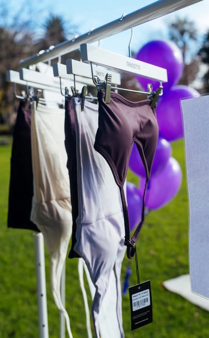 Outdoor event styling with a clothing rack and purple balloons