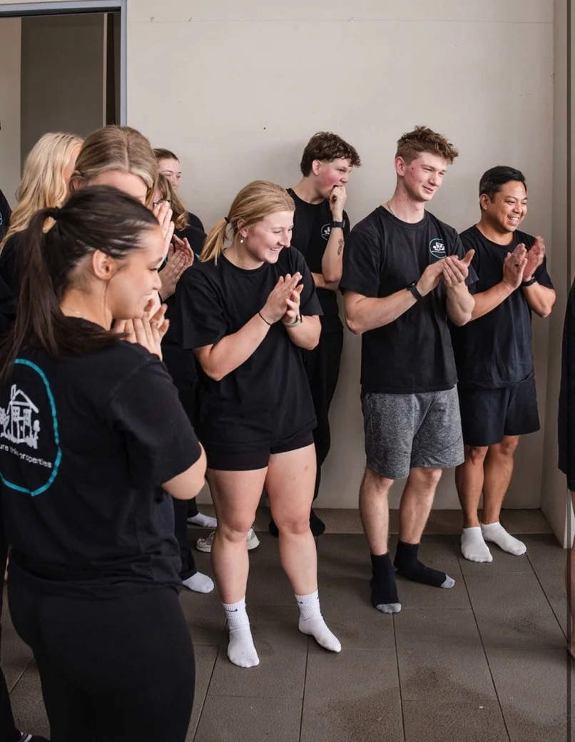 Colleagues applauding together at an Atlas team event